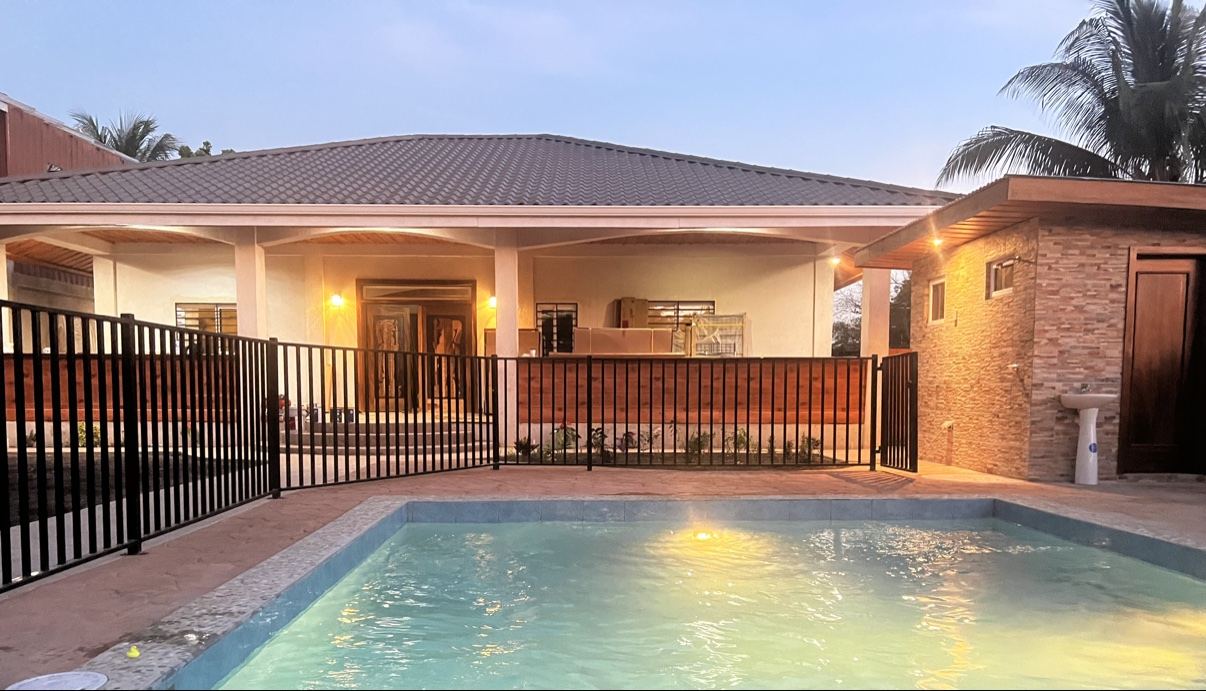 Paradise Palms villa and illuminated pool at dusk