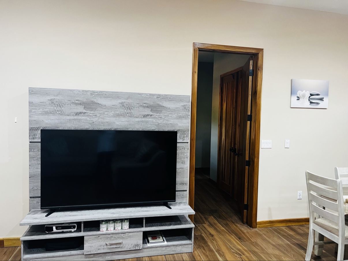 Paradise Palms living room with a television and wood-look floors