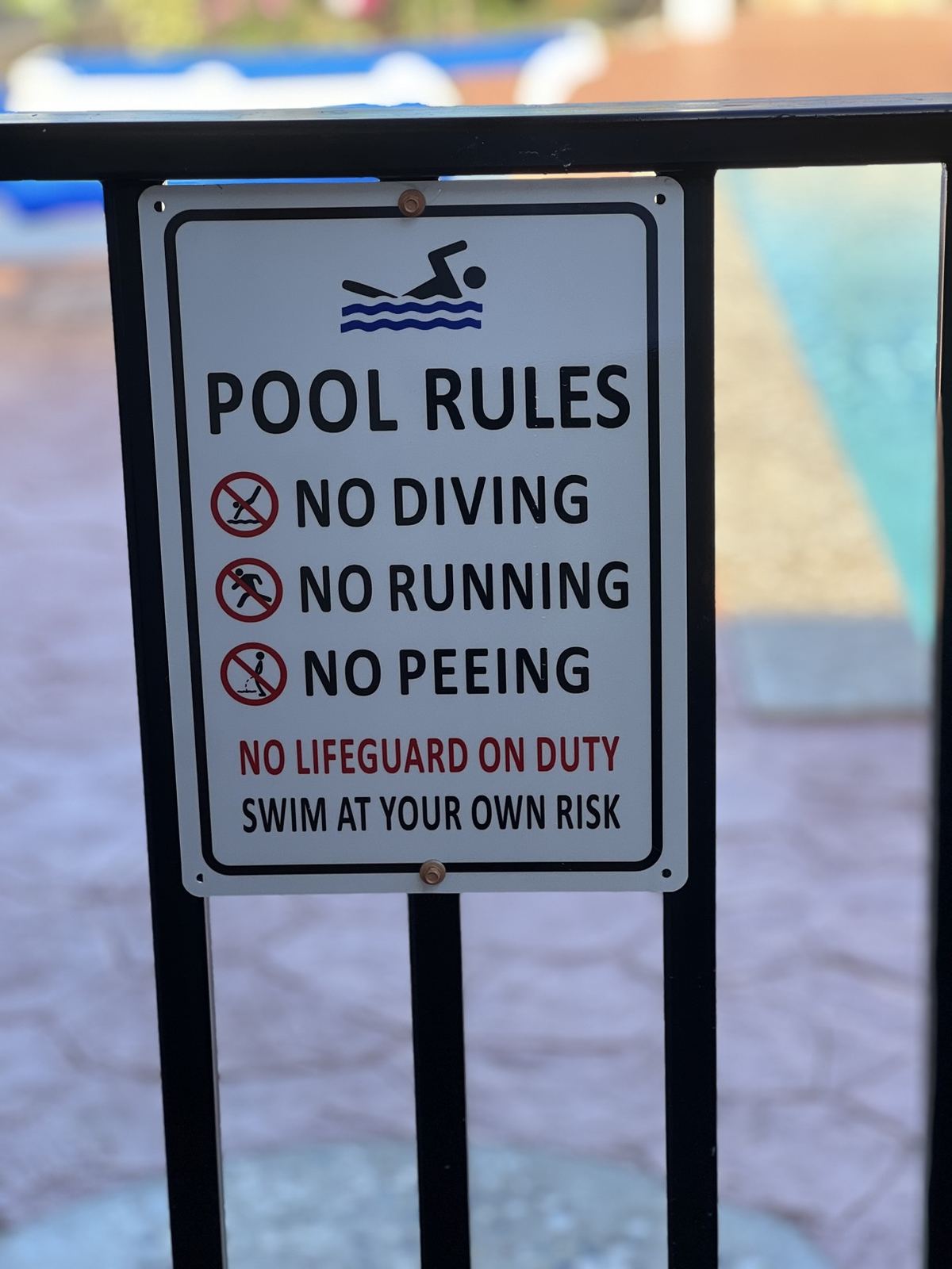 Pool safety rules posted beside the Paradise Palms pool